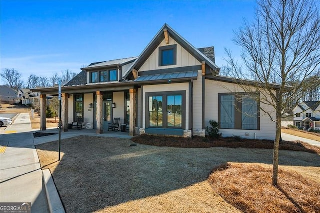 view of front of house with a standing seam roof, metal roof, a porch, and board and batten siding