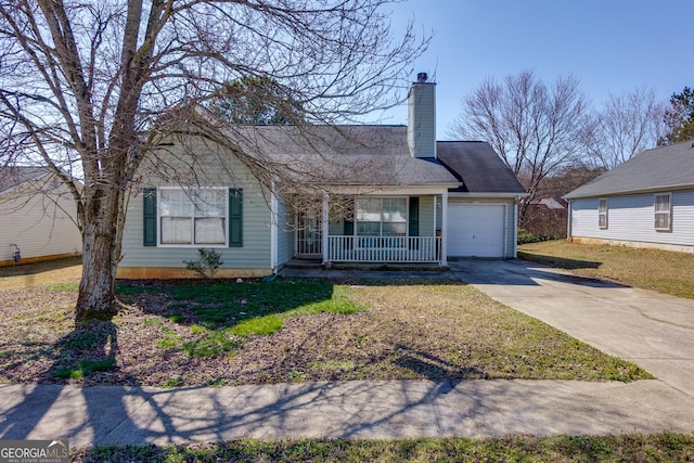 view of front of property featuring a chimney, covered porch, concrete driveway, an attached garage, and a front lawn