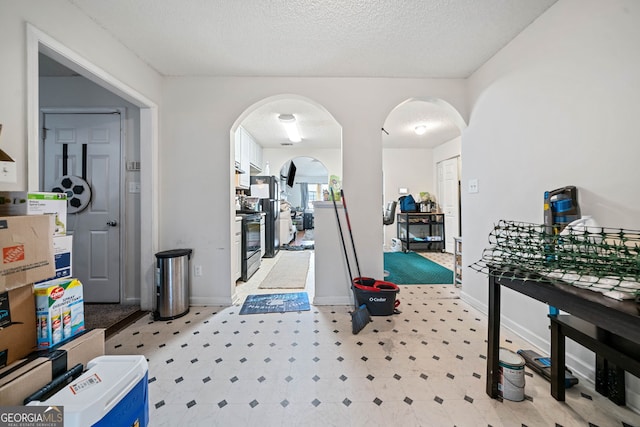 recreation room featuring a textured ceiling