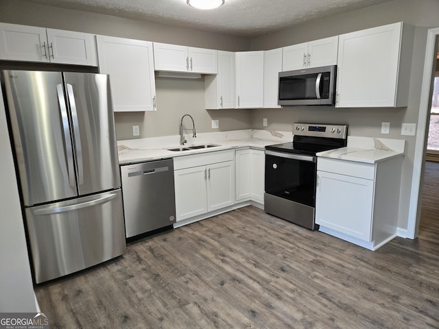 kitchen with white cabinetry, sink, and appliances with stainless steel finishes