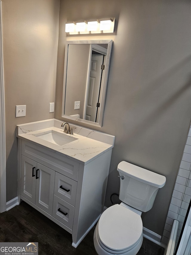 bathroom featuring hardwood / wood-style flooring, vanity, and toilet