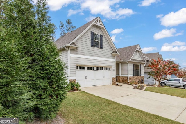 craftsman-style house with a garage and a front lawn