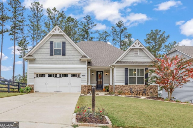 773 Riverwalk Manor Dr, Dallas, GA 30132 - craftsman-style house featuring concrete driveway, a garage, stone siding, and a shingled roof