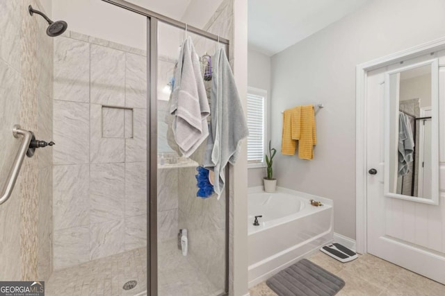 bathroom with tile patterned floors and separate shower and tub