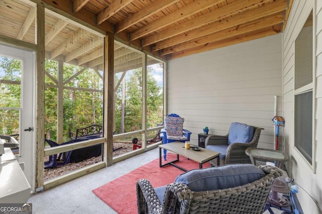 sunroom with beamed ceiling, plenty of natural light, and wooden ceiling