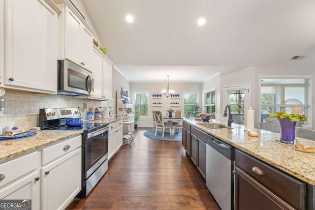773 Riverwalk Manor Dr, Dallas, GA 30132 - kitchen with stainless steel appliances, a sink, a chandelier, white cabinets, and dark wood-type flooring