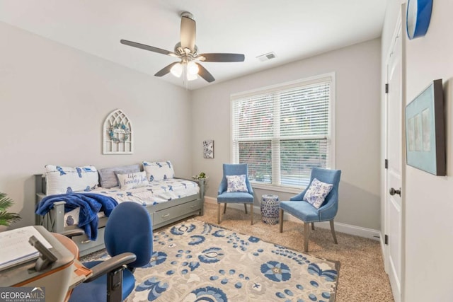 bedroom with ceiling fan, carpet flooring, and multiple windows