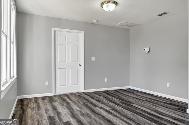 spare room featuring dark hardwood / wood-style flooring