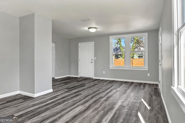 unfurnished room featuring dark hardwood / wood-style flooring