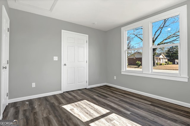 unfurnished bedroom with dark hardwood / wood-style flooring