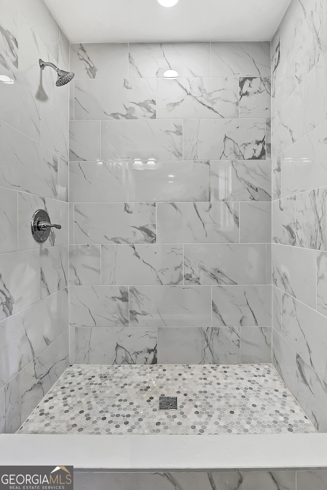 bathroom with tiled shower