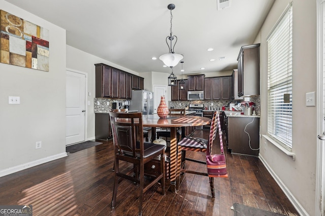 dining room with dark hardwood / wood-style floors