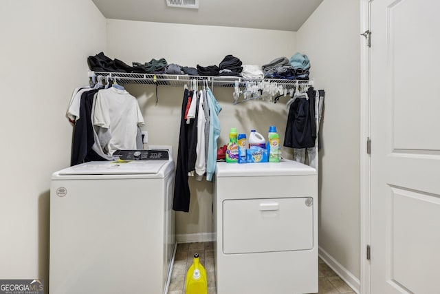 laundry area featuring separate washer and dryer and light tile patterned flooring