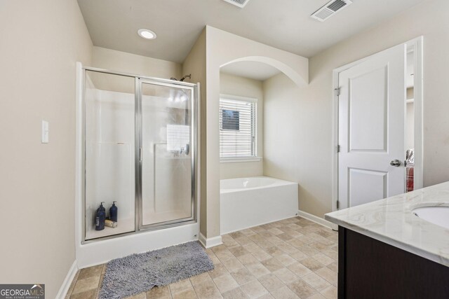 bathroom featuring vanity and an enclosed shower