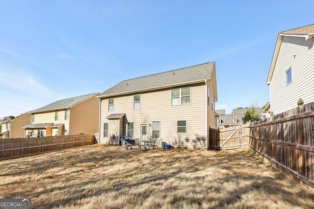 rear view of property featuring a yard