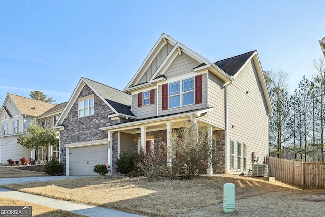 view of front of home featuring cooling unit and a garage