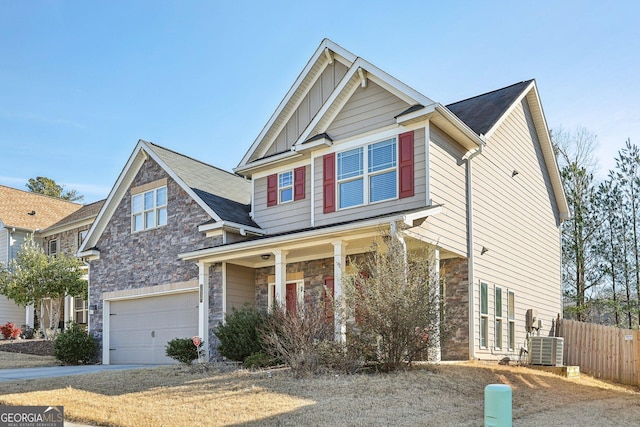 craftsman inspired home featuring a garage, a porch, and central AC