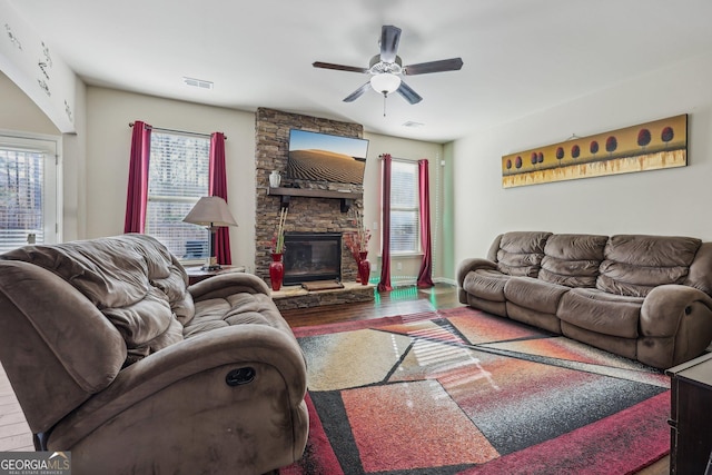 living room with ceiling fan, dark wood-type flooring, and a fireplace