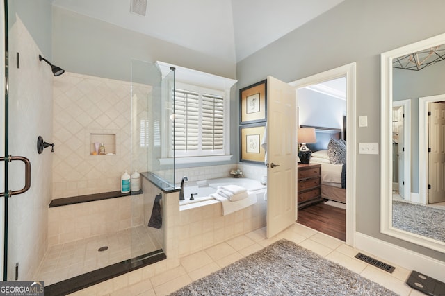 bathroom featuring tile patterned floors and shower with separate bathtub