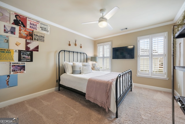 bedroom with crown molding, ceiling fan, and carpet