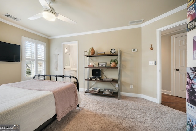 carpeted bedroom with ceiling fan, ornamental molding, and ensuite bathroom