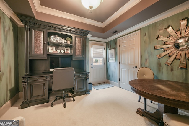 carpeted office space with a raised ceiling and crown molding