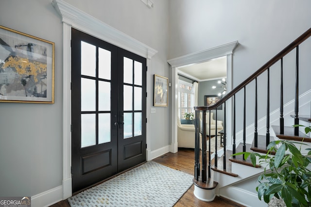 entryway featuring ornamental molding, dark hardwood / wood-style flooring, and french doors