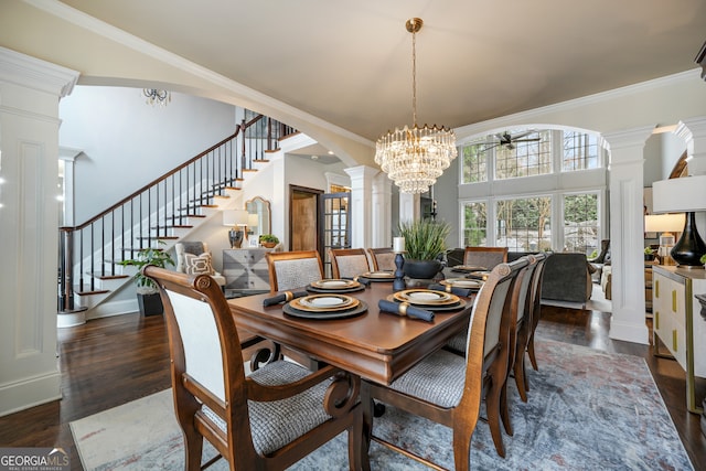 dining space with an inviting chandelier, ornamental molding, dark hardwood / wood-style flooring, and decorative columns