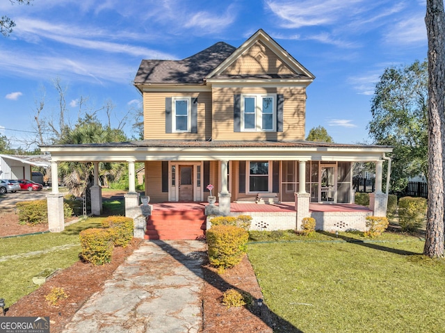 view of front of home with covered porch and a front lawn