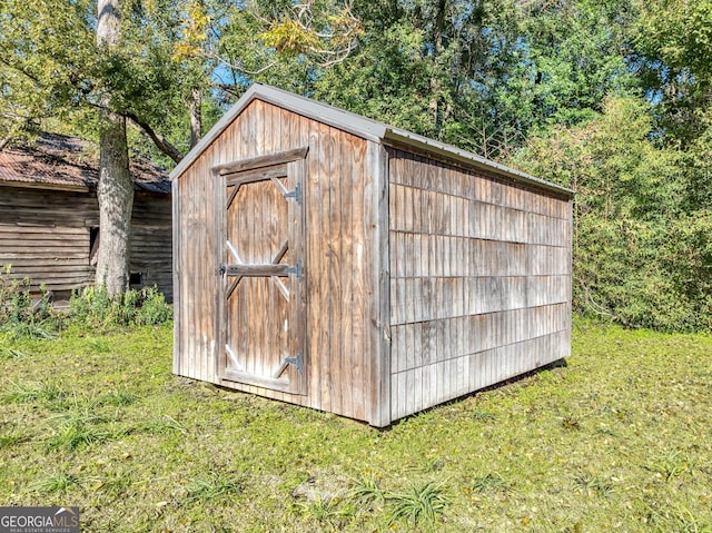 view of outbuilding with a lawn