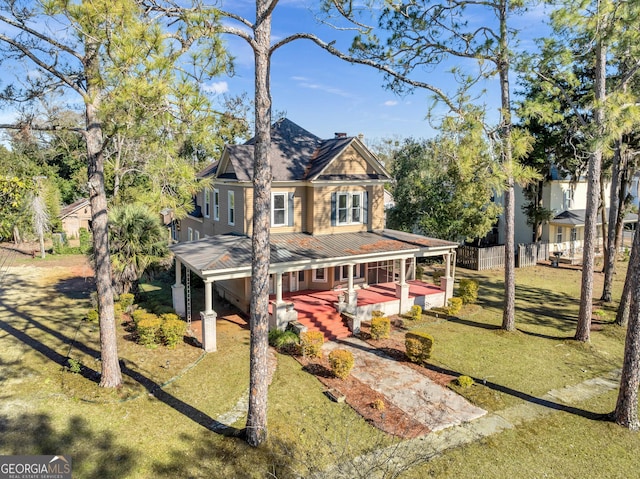 view of front of property with a porch and a front yard