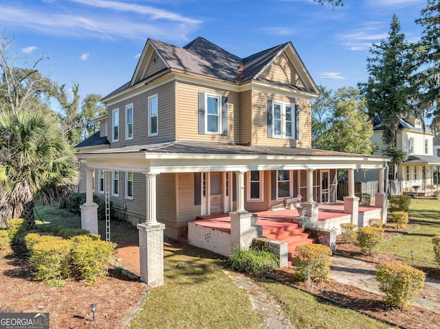 view of front of home with a front yard and a porch