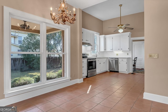 kitchen featuring light tile patterned flooring, appliances with stainless steel finishes, sink, and white cabinets