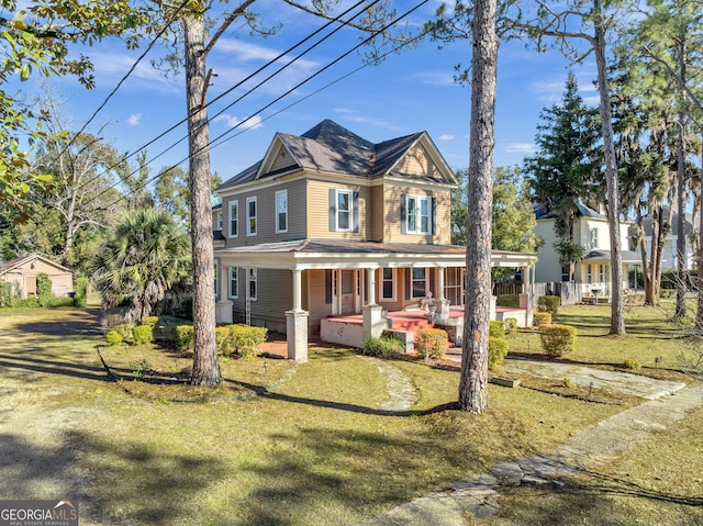 view of front of property featuring covered porch and a front yard