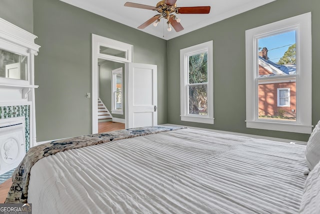 unfurnished bedroom featuring a fireplace and ceiling fan