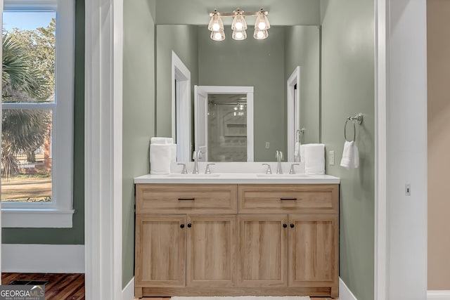 bathroom featuring vanity, a wealth of natural light, and walk in shower