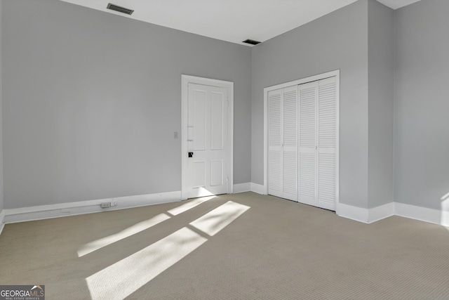 unfurnished bedroom with carpet flooring and a closet