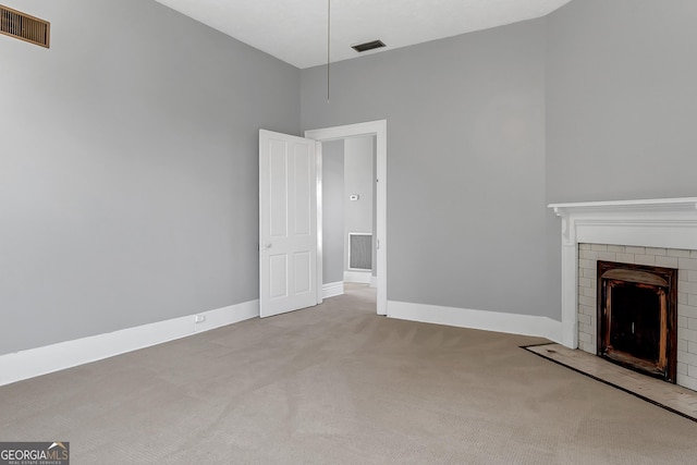 unfurnished living room with a fireplace and carpet floors