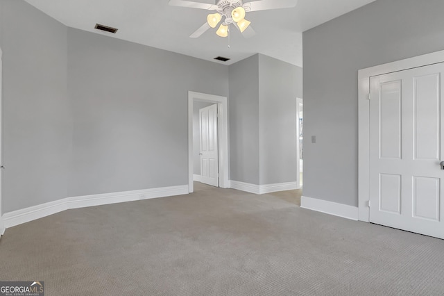 carpeted spare room with ceiling fan