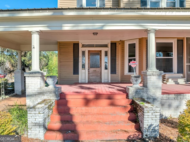 view of exterior entry featuring a porch