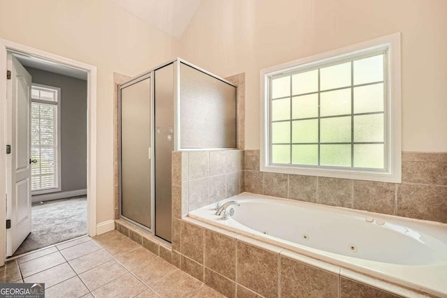 bathroom with shower with separate bathtub, lofted ceiling, and tile patterned floors