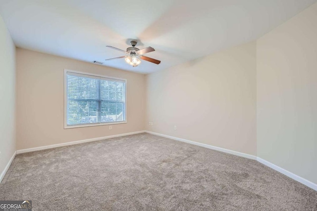 unfurnished room featuring carpet floors and ceiling fan