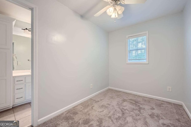 carpeted empty room with ceiling fan