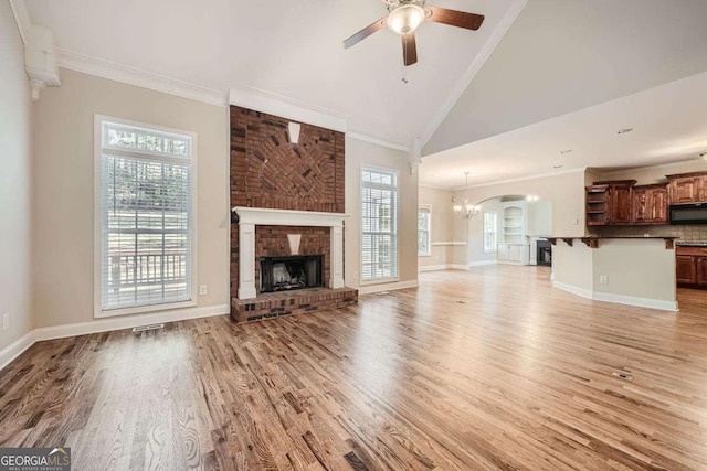 unfurnished living room featuring crown molding, a fireplace, and light wood-type flooring