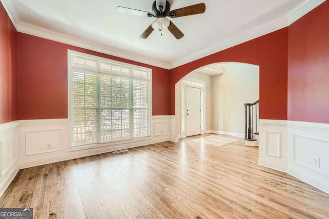 spare room featuring crown molding, ceiling fan, and light hardwood / wood-style floors