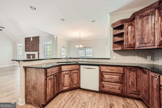 kitchen with sink, an inviting chandelier, light hardwood / wood-style flooring, ornamental molding, and white dishwasher