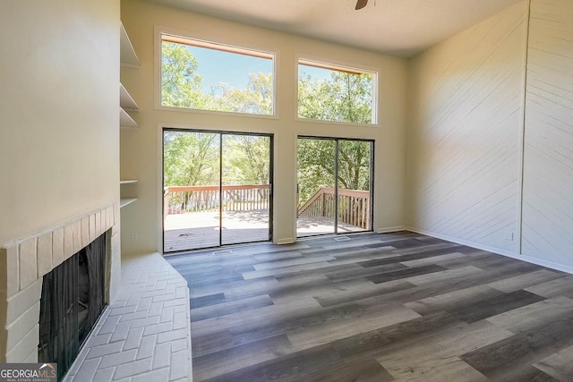 living room with a towering ceiling and a healthy amount of sunlight