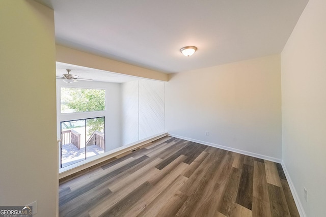 unfurnished room featuring dark wood-type flooring