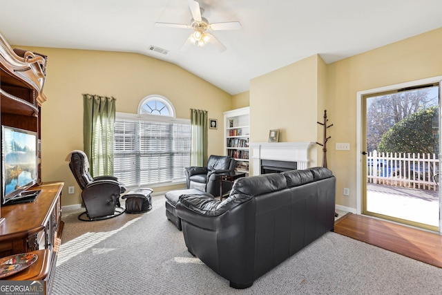 living room featuring vaulted ceiling and ceiling fan