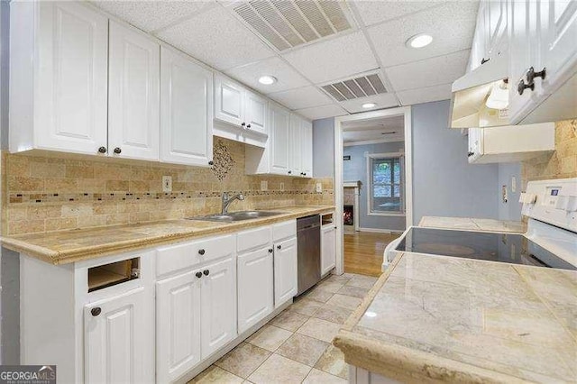 kitchen featuring white cabinetry, dishwasher, sink, white electric range oven, and a drop ceiling